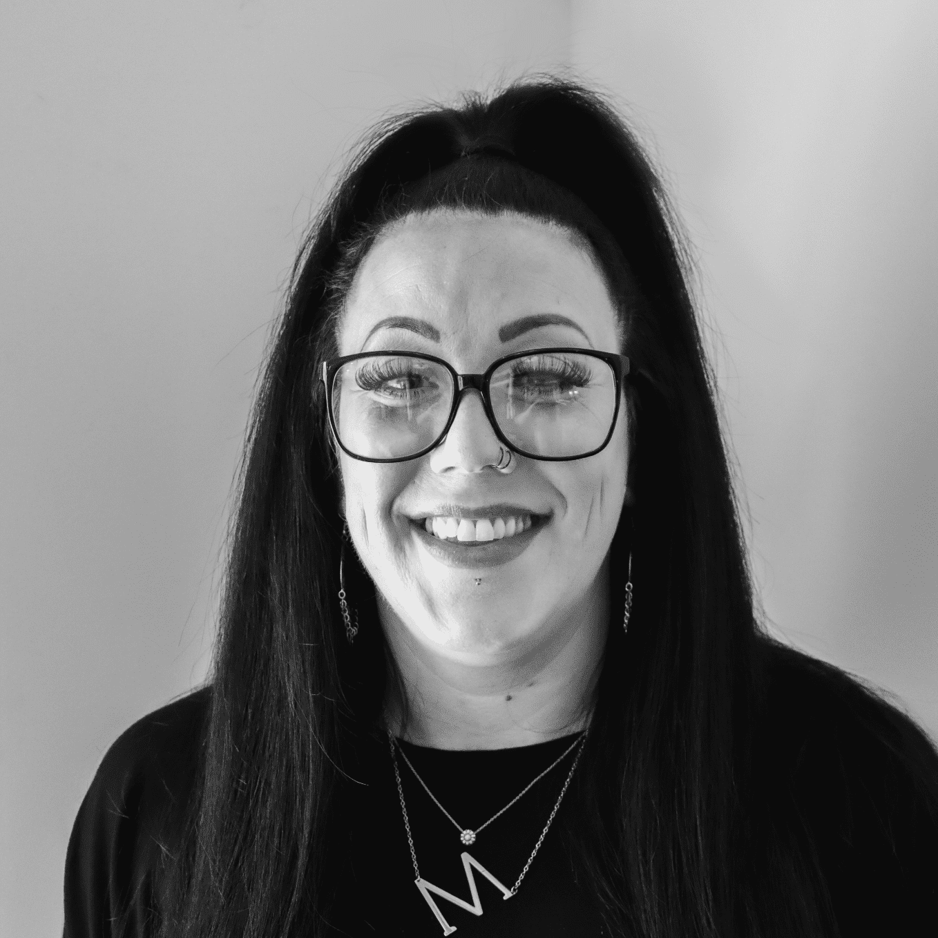 Portrait of MK, a professional stylist at Jungle Red Salon, showcasing their expertise and style.