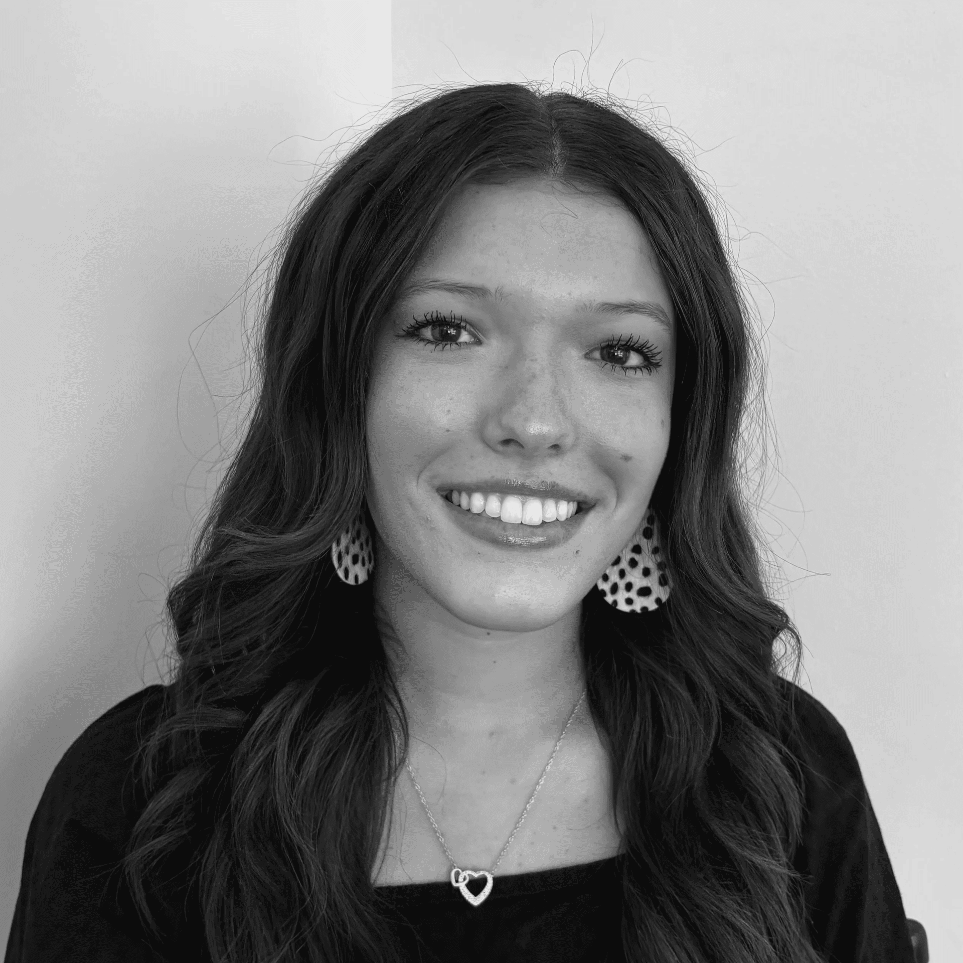 Portrait of Caroline, a professional stylist at Jungle Red Salon, showcasing their expertise and style.