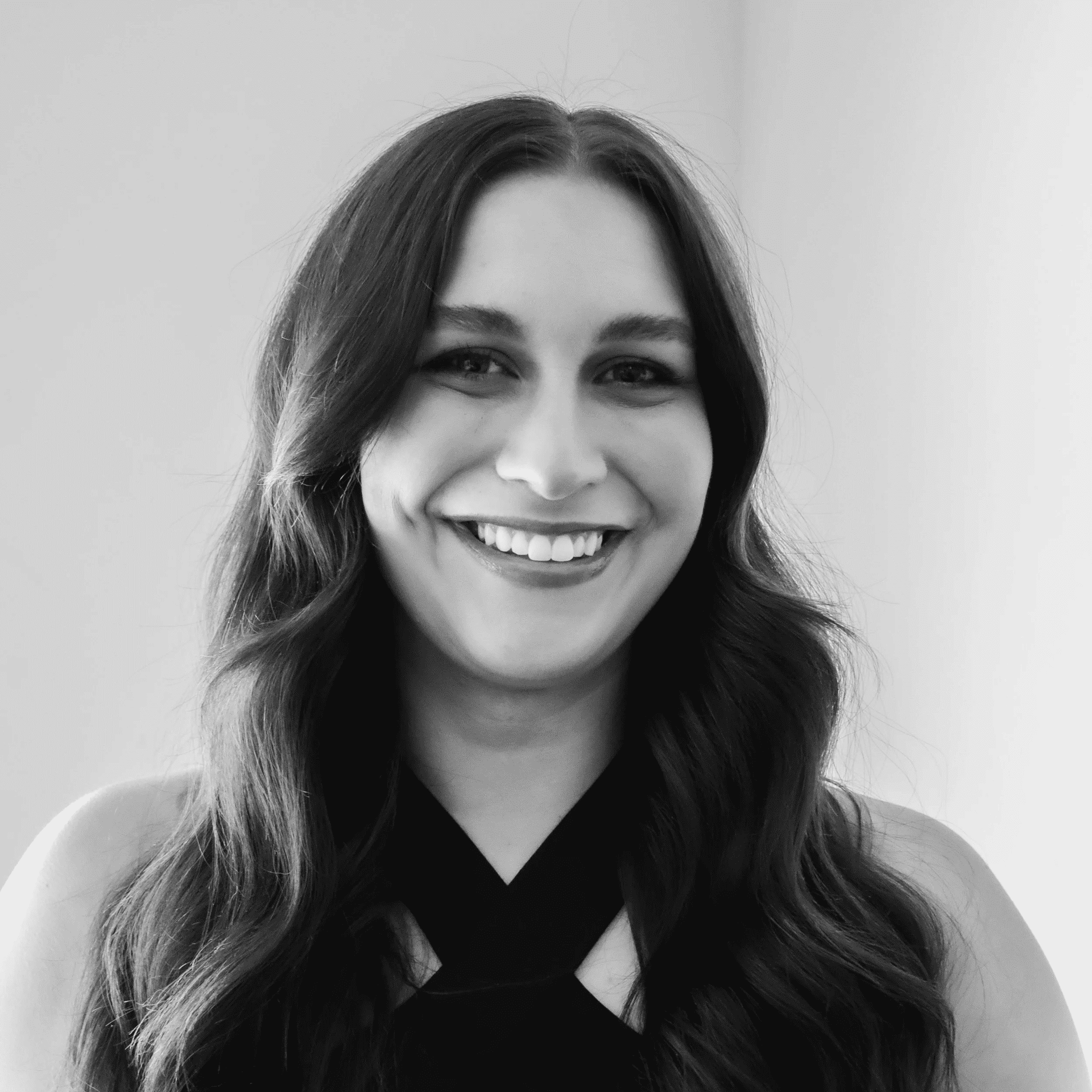 Portrait of Bre, a professional stylist at Jungle Red Salon, showcasing their expertise and style.