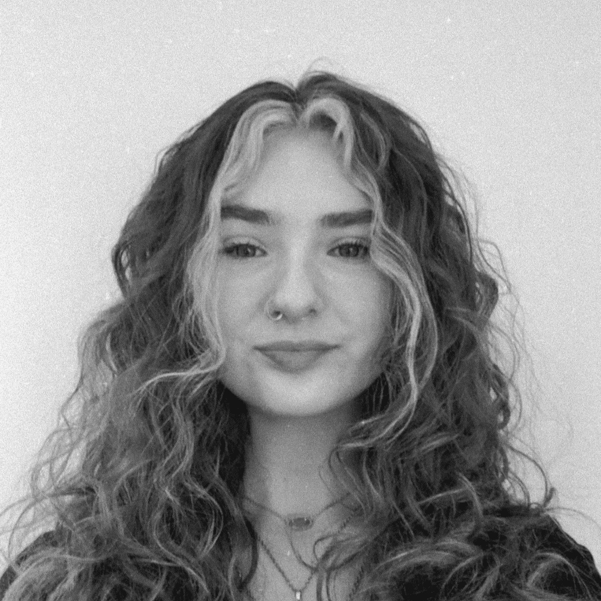 Portrait of Grace, a professional stylist at Jungle Red Salon, showcasing their expertise and style.