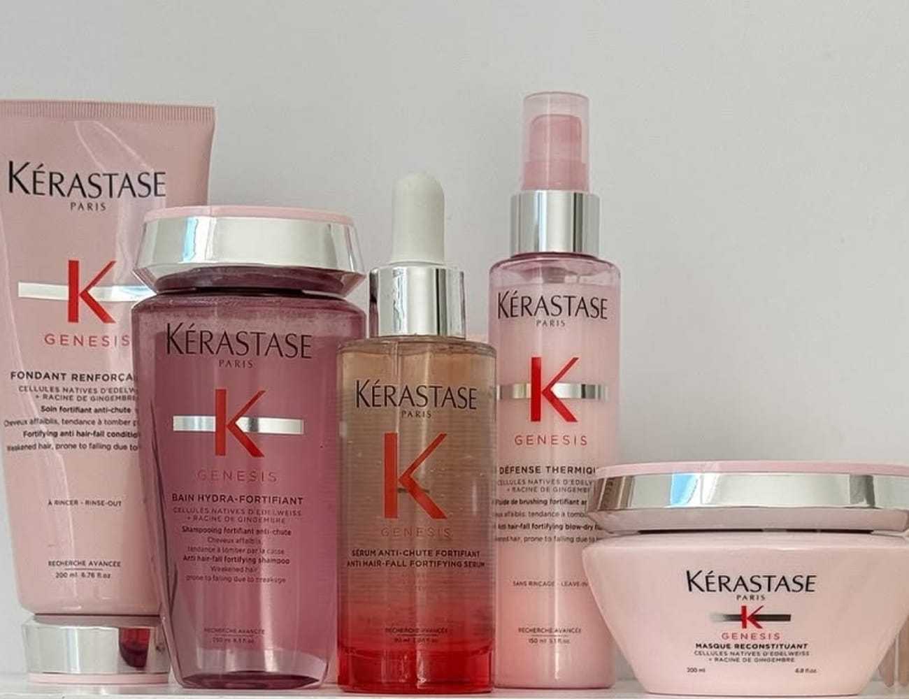 Kérastase Genesis hair care products arranged on a neutral background.