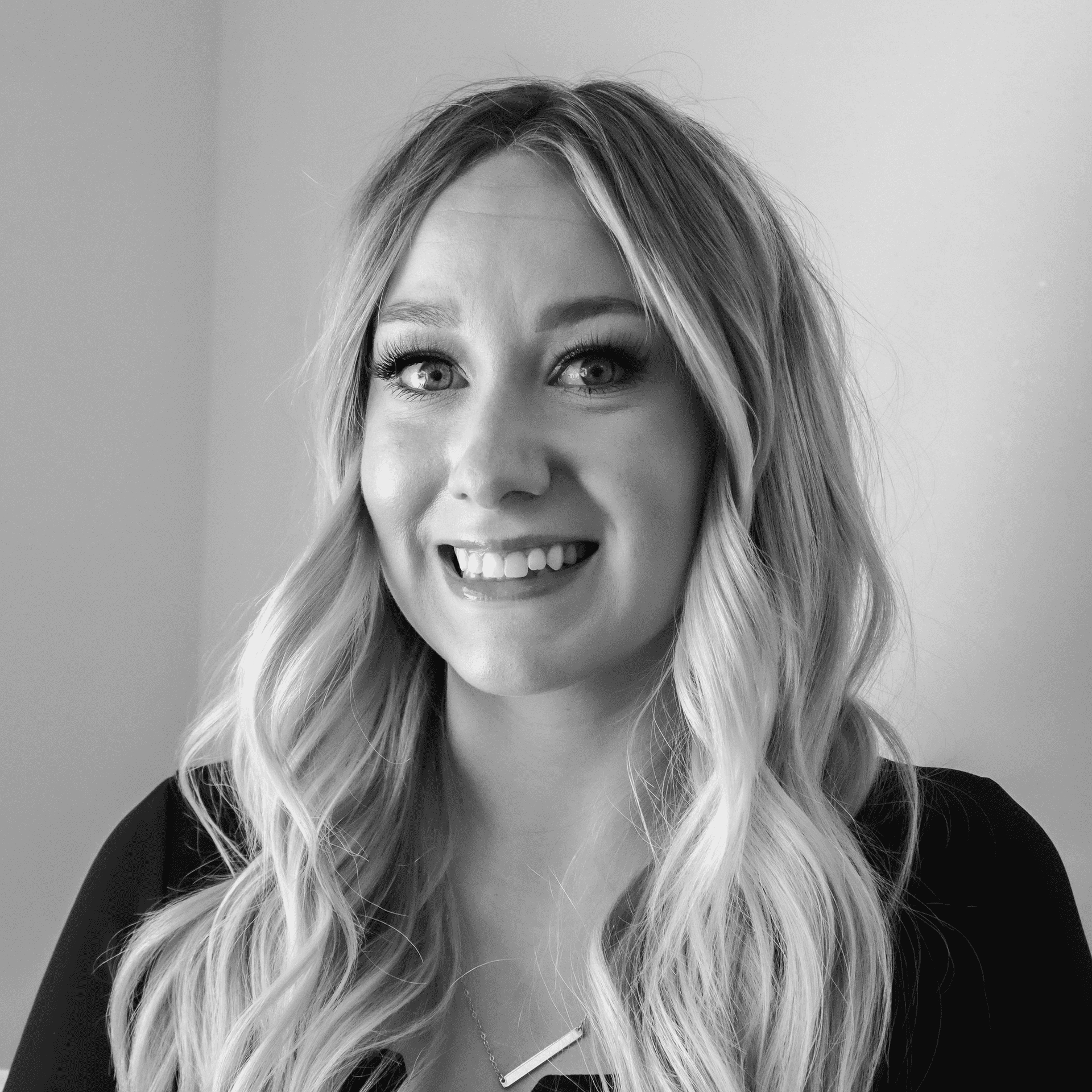 Portrait of Andrea, a professional stylist at Jungle Red Salon, showcasing their expertise and style.