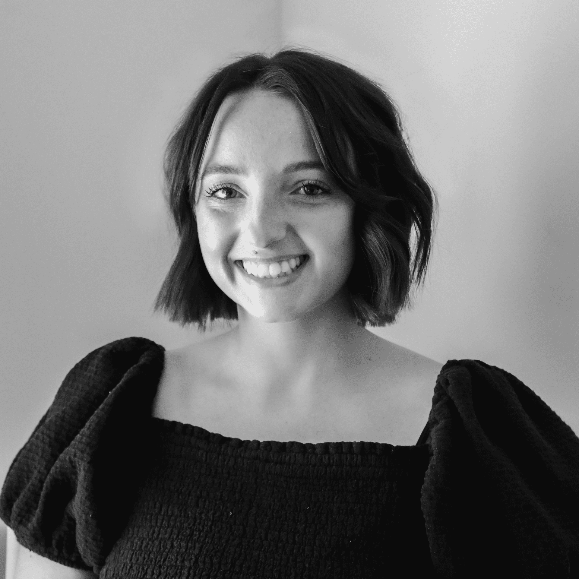 Portrait of Faith, a professional stylist at Jungle Red Salon, showcasing their expertise and style.