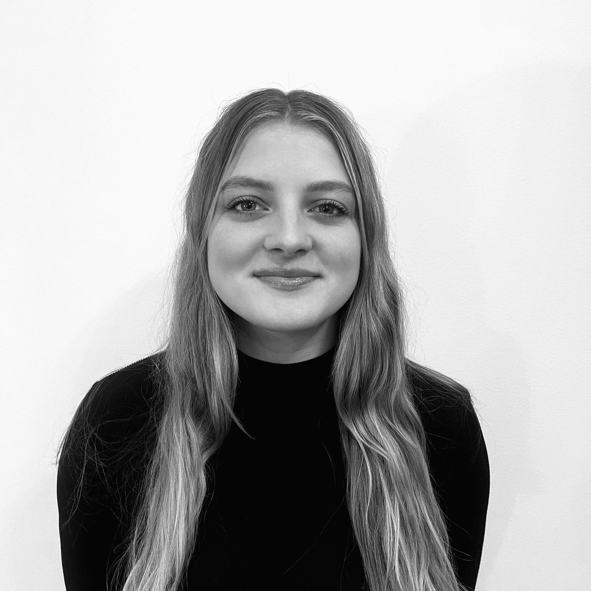 Portrait of Trinity, a professional stylist at Jungle Red Salon, showcasing their expertise and style.