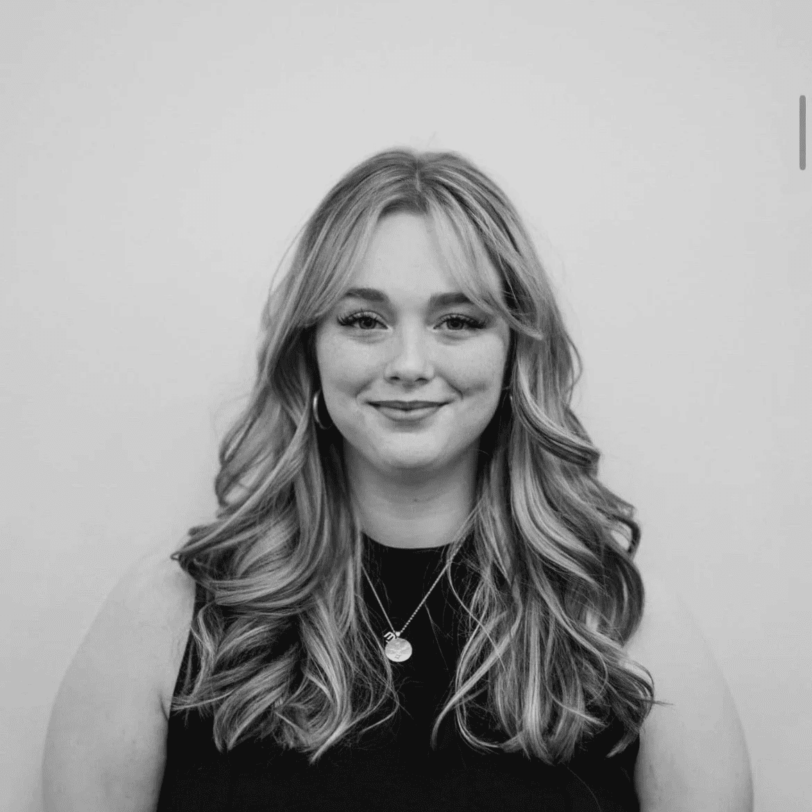 Portrait of Edy, a professional stylist at Jungle Red Salon, showcasing their expertise and style.