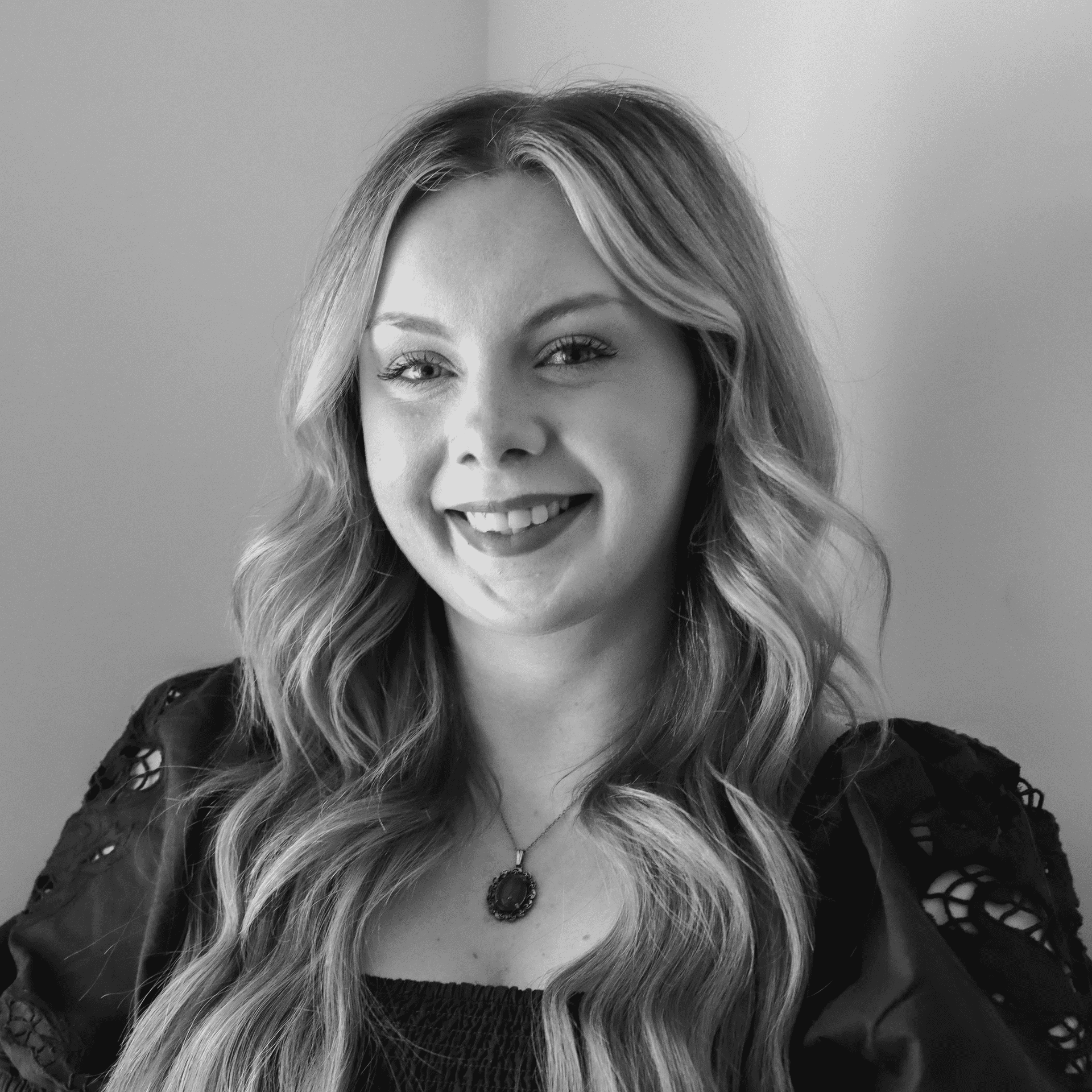 Portrait of Kelsea, a professional stylist at Jungle Red Salon, showcasing their expertise and style.