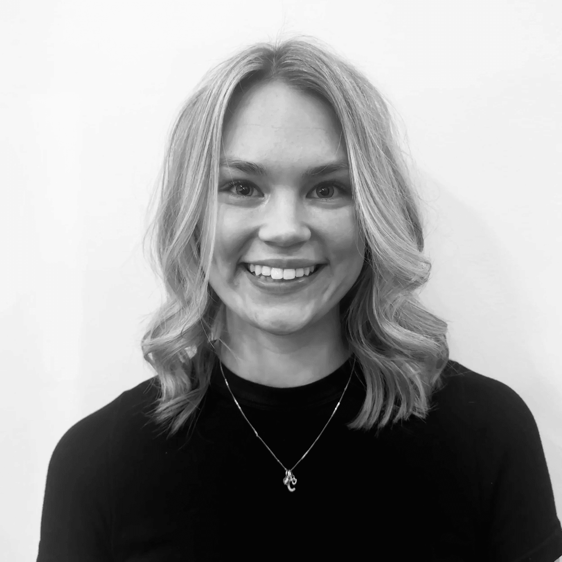 Portrait of Makayla, a professional stylist at Jungle Red Salon, showcasing their expertise and style.