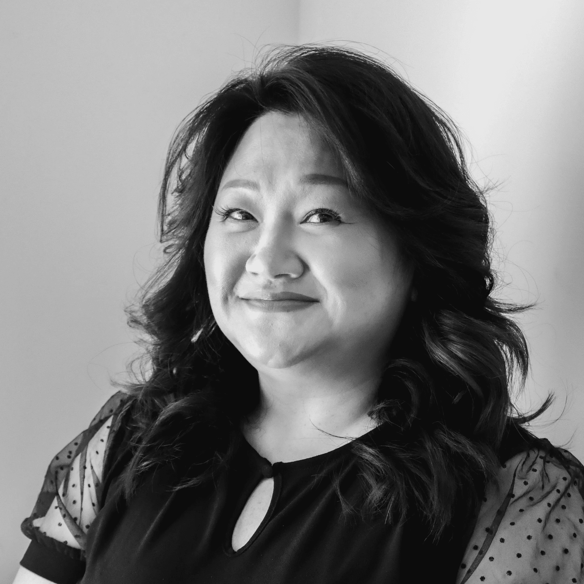 Portrait of Lee, a professional stylist at Jungle Red Salon, showcasing their expertise and style.