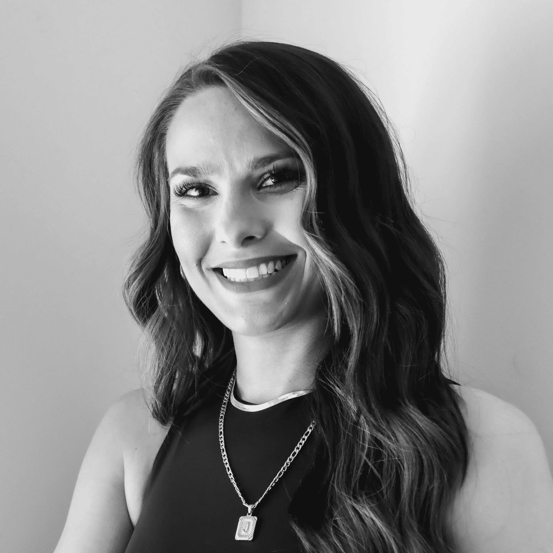 Portrait of Jenny, a professional stylist at Jungle Red Salon, showcasing their expertise and style.