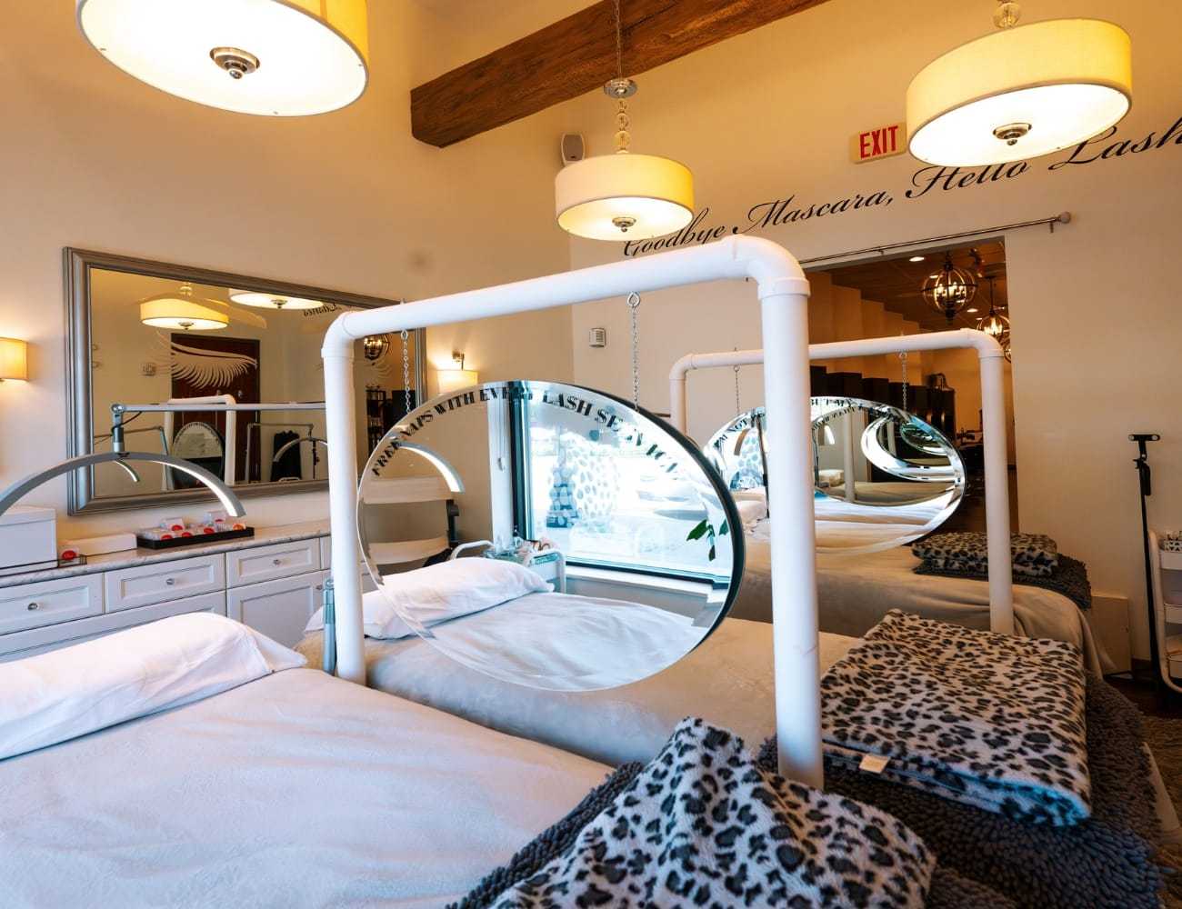 Cozy beauty salon with treatment beds and elegant lighting.