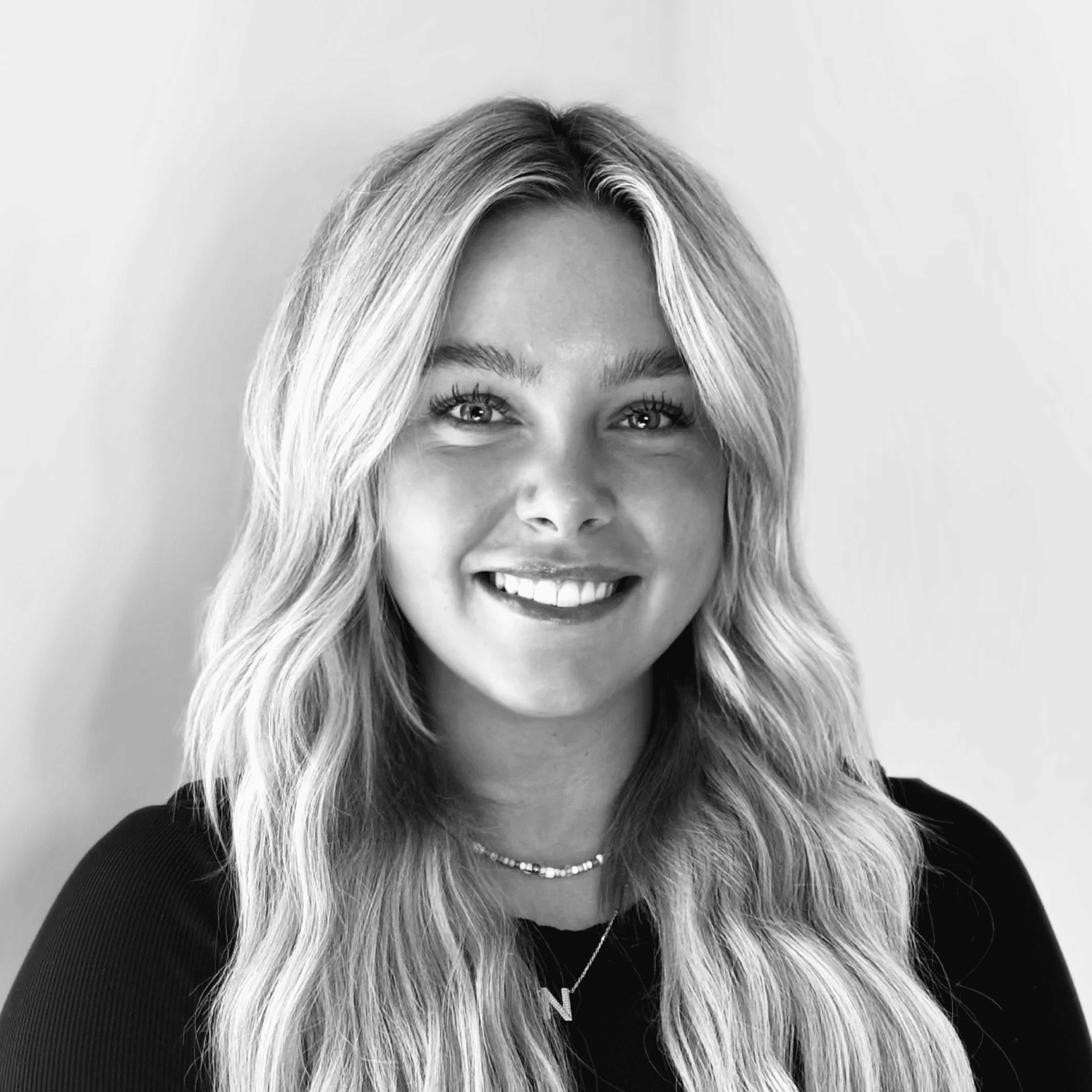 Portrait of Peyton, a professional stylist at Jungle Red Salon, showcasing their expertise and style.
