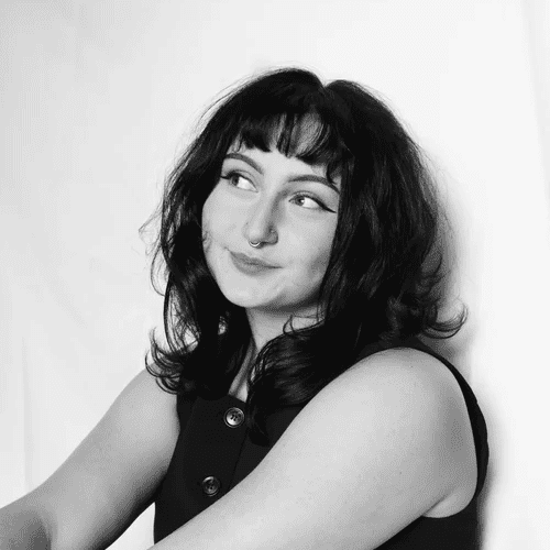 Portrait of Stella, a professional stylist at Jungle Red Salon, showcasing their expertise and style.