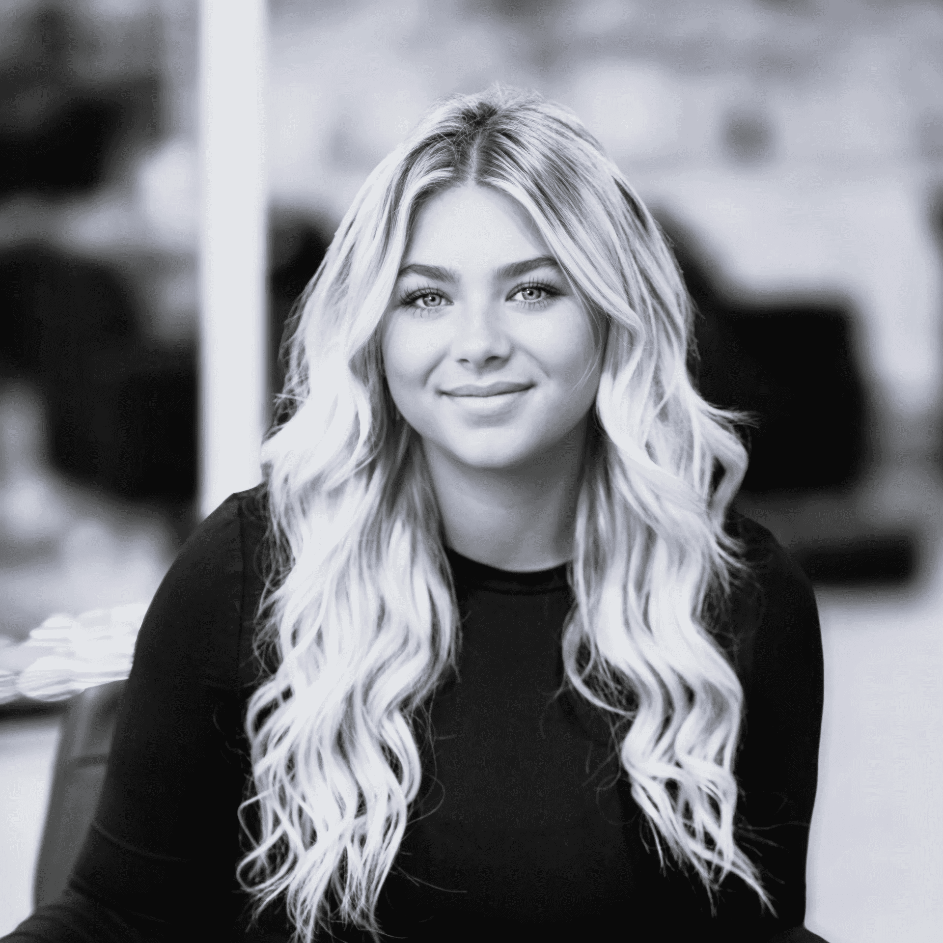 Portrait of Bailey, a professional stylist at Jungle Red Salon, showcasing their expertise and style.