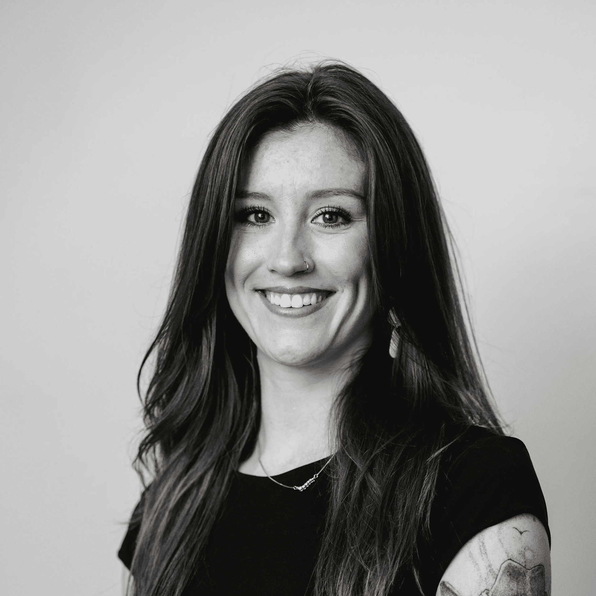 Portrait of Reagan, a professional stylist at Jungle Red Salon, showcasing their expertise and style.